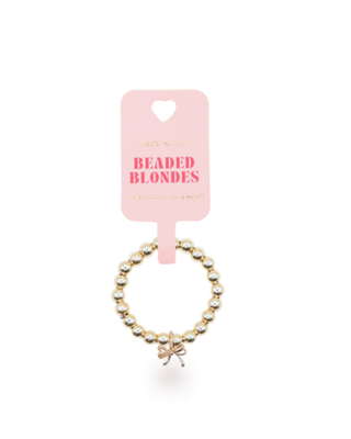 Beaded ring with bow charm with a pink card labeled 'Beaded Blondes' on a white background