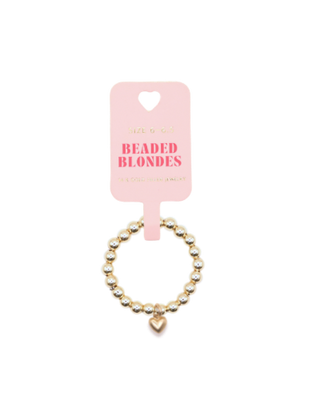 Beaded ring with heart charm with a pink card labeled 'Beaded Blondes' on a white background