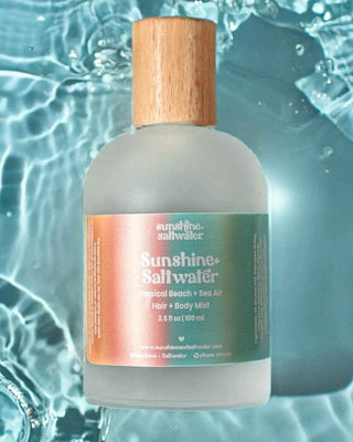 Bottle of Sunshine Saltwater product with a wooden cap on a water background