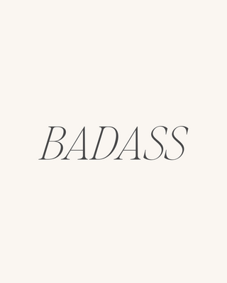 The word 'BADASS' is centered in a dark gray serif font on a solid off-white background.