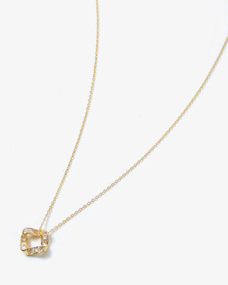 Gold necklace with a geometric pendant on a white background