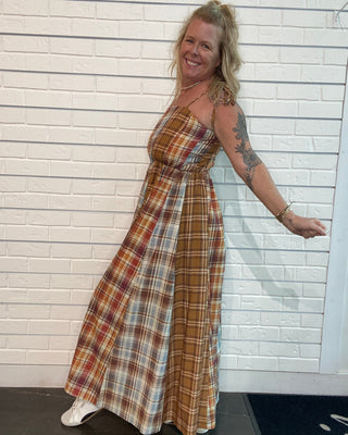 A flowy fall maxi dress with warm plaid, adjustable straps, smocked back