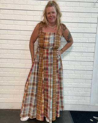 A flowy fall maxi dress with warm plaid, adjustable straps, smocked back