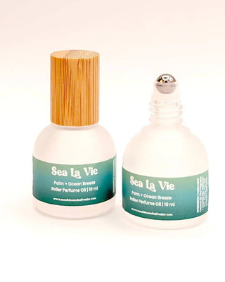 Two bottles of Sea La Vie perfume oil with different bottle designs on a white background