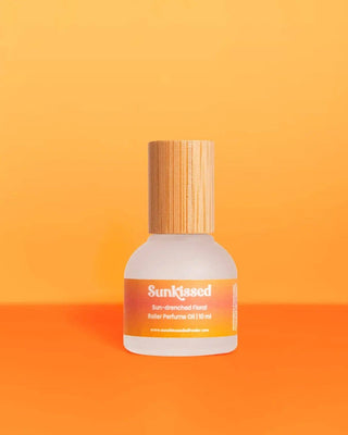 Perfume bottle labeled 'Sunkissed' on an orange background
