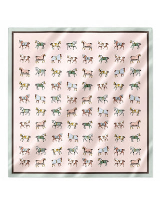 A square scarf featuring a grid pattern of small illustrated horses in various colors on a pale pink background, finished with a dark brown border and a light sage green edge.