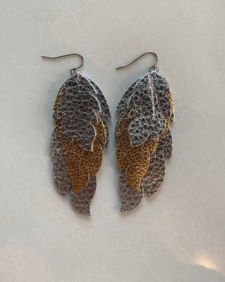 Pair of leaf-shaped earrings on a light gray background