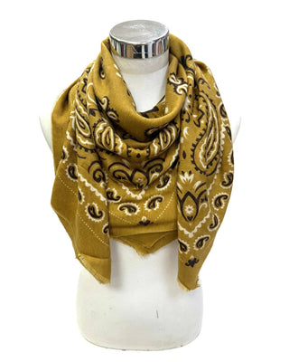 A mustard yellow bandana scarf with a black and white paisley pattern, draped on a white mannequin torso against a white background.