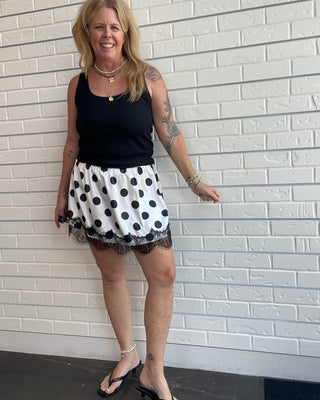 Polka Dot Lace Skirt at Ellipsis Boutique. A flowy satin skirt with a polka dot pattern, stretchy waist, and lace trim.