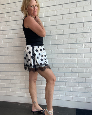 Polka Dot Lace Skirt at Ellipsis Boutique. A flowy satin skirt with a polka dot pattern, stretchy waist, and lace trim.