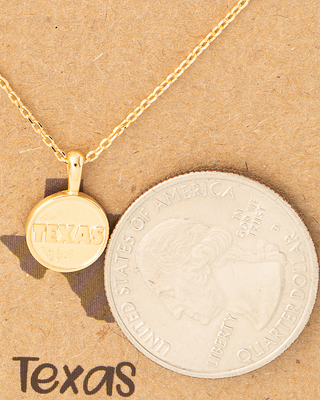 Gold necklace with a 'Texas' pendant on a brown background with text.
