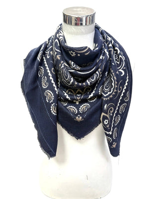 A navy blue bandana scarf with a white paisley pattern, draped on a white mannequin torso against a white background.