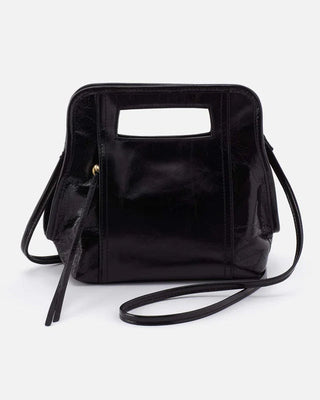 Black handbag with a unique handle design on a white background