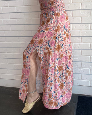 Women's multicolor floral midi skirt with a pintuck waist, side slit, flowy silhouette, and pull-on design side view
