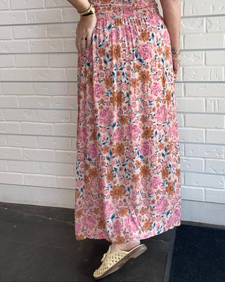 Women's multicolor floral midi skirt with a pintuck waist, side slit, flowy silhouette, and pull-on design back view
