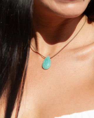 Tula Blue amazonite teardrop pendant on brown rope, worn around the neck.