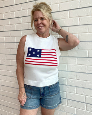 woman wearing white sweater tank with american flag 