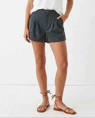 Woman wearing a white top and gray shorts on a white background