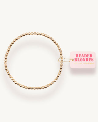 Gold beaded anklet with 'Beaded Blondes' label on a white background