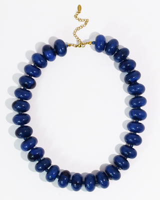 Blue beaded necklace on a white background