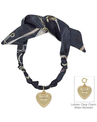 A black silk scarf with gold chain and white stripe patterns, styled as a collar with a lobster clasp charm. An inset image in the bottom right shows the water-resistant, lobster clasp heart charm.