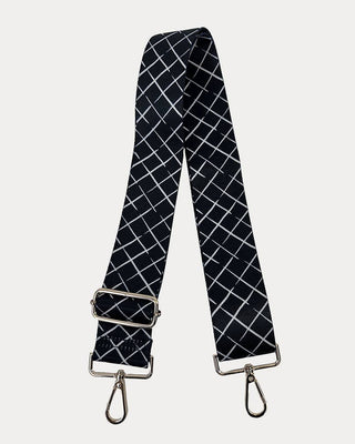 Black and white checkered bag strap on a light gray background