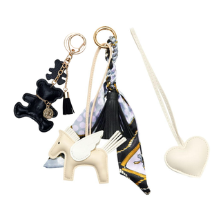 Set of keychains including a bear, unicorn, and heart design on a white background
