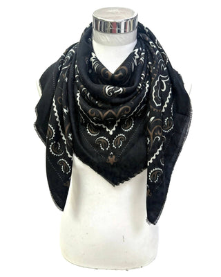 A black square scarf with a white and brown paisley pattern, draped on a white mannequin torso against a white background.