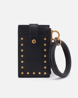 Black studded pouch with a gold ring on a white background