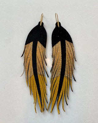 Pair of feather earrings with black, gold, and beige colors on a light gray background