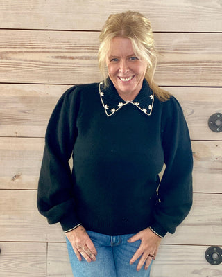 black sweater with white detail collar