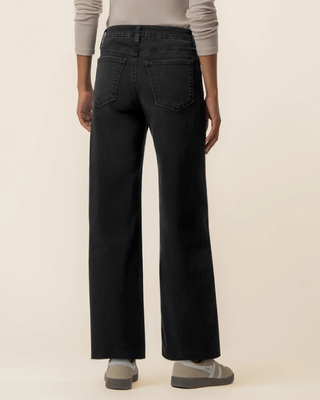 woman facing back in black jeans