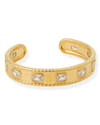Gold bracelet with embedded stones on a white background