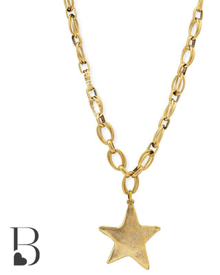 Gold chain necklace with a star pendant on a white background