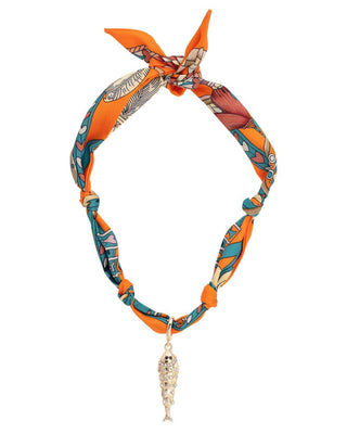 Colorful patterned scarf necklace with a skull charm on a white background