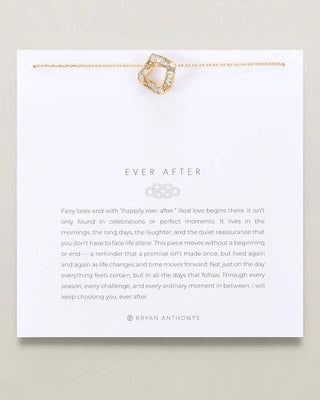 A white jewelry gift card from Bryan Anthony's featuring a gold chain necklace with a gold and clear crystal heart pendant, above printed text that reads 'EVER AFTER' and a quote about fairy tales and real love.