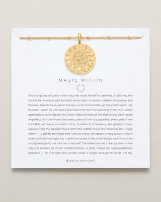 Gold necklace with a pendant on a card with text on a beige background