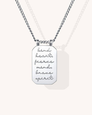 Silver necklace with engraved pendant on a white background
