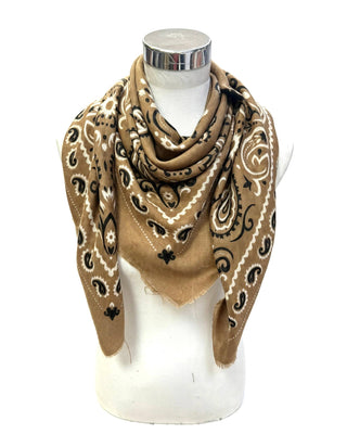 A tan bandana scarf with black and white paisley patterns, draped on a white mannequin torso against a white background.