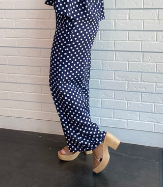 Women's navy and white polka dot wide-leg trousers with a smocked waistband, pull-on fit, front pockets, and a relaxed drapey silhouette side picture