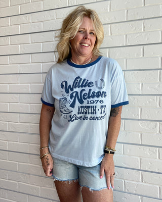 Women's Willie Nelson Austin 1976 graphic ringer tee with contrast navy trim, short sleeves, and a vintage-inspired Texas country music design.
