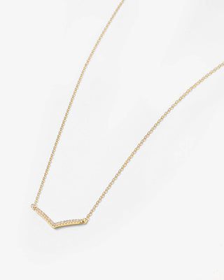 A delicate gold chain necklace featuring a small, textured chevron-shaped pendant, displayed on a clean white background.