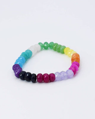 A beaded stretch bracelet arranged in a rainbow sequence of faceted gemstone beads on a clean white background.