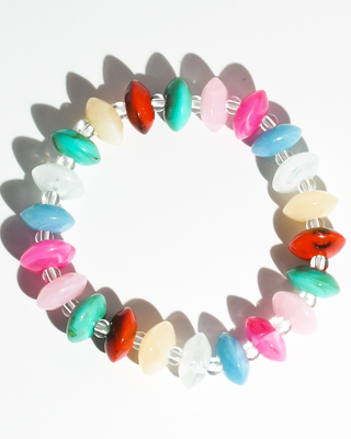 A beaded stretch bracelet made of glossy, elongated oval beads in multiple colors including pink, blue, green, red, white, and beige, separated by small silver spacer beads, shown on a plain white background with soft shadows.