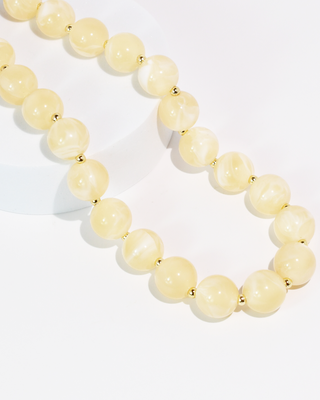 Necklace with cream beads on a white background