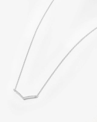 A delicate silver chain necklace featuring a V-shaped pendant paved with small clear stones, displayed on a clean white background.