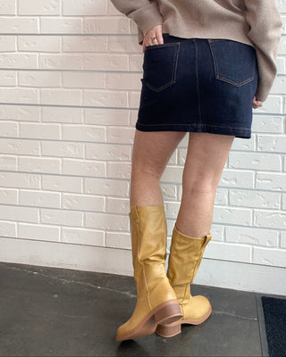 Z Supply Socialite Denim Mini Skirt in Midnight Air. A dark indigo stretch denim mini with five pockets and classic gold hardware.