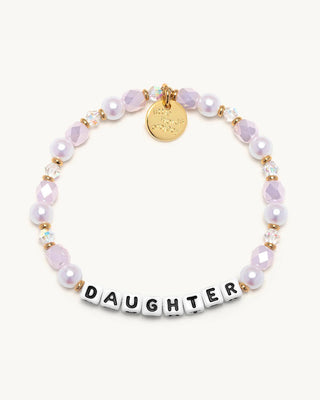 Bracelet with pink beads and a gold tag on a white background