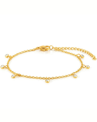 Gold anklet with small beads on a white background