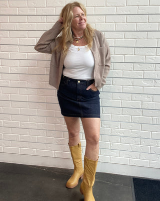 Z Supply Socialite Denim Mini Skirt in Midnight Air. A dark indigo stretch denim mini with five pockets and classic gold hardware.